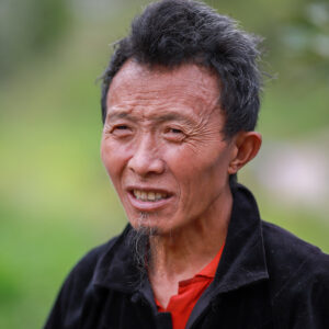 Close-up portrait of an elderly man in Lào Cai, Vietnam, showcasing cultural identity.